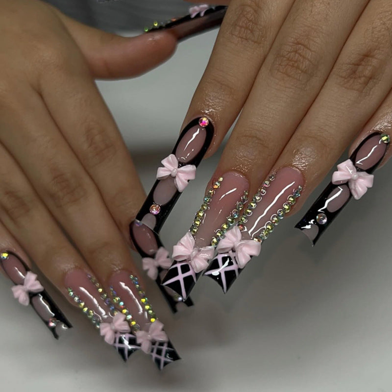Artistic acrylic nails with floral design and rhinestone bow Stornfield