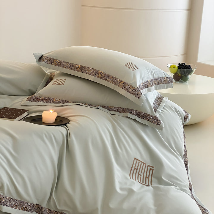Luxurious bedding set made of cotton satin with paisley border and monogram embroidery