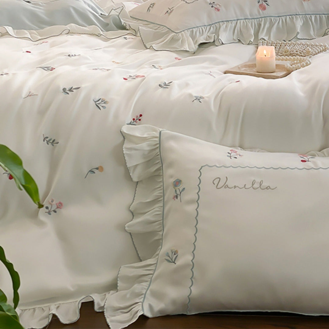 Romantic cotton satin bedding set with delicate floral embroidery and ruffle trim