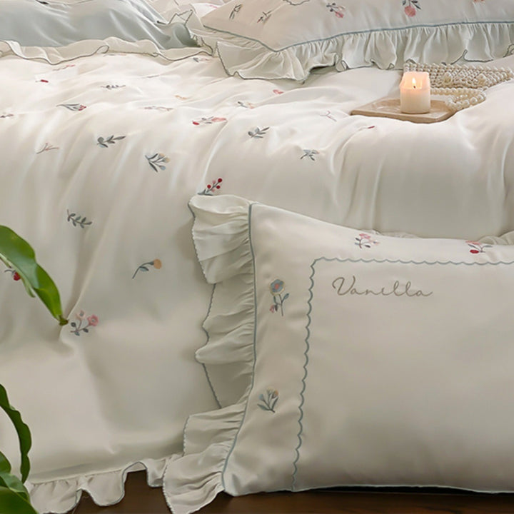 Romantic cotton satin bedding set with delicate floral embroidery and ruffle trim