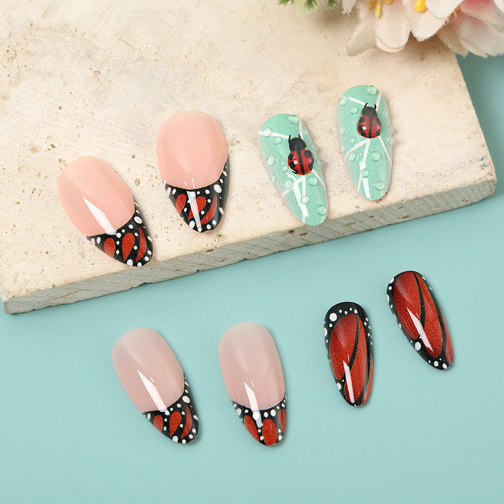 Creative nail art with elaborate butterfly and flower designs Stornfield