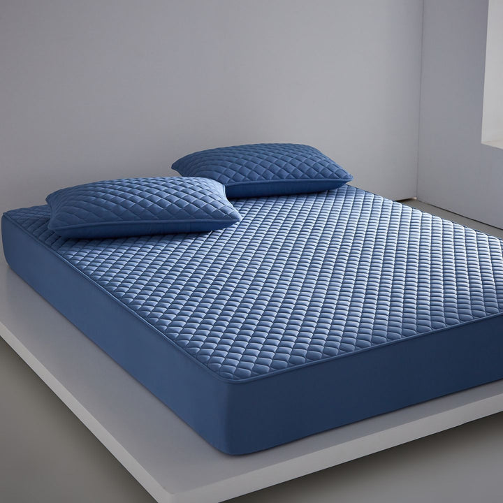 Breathable cooling mattress topper with quilted surface and elastic corner bands