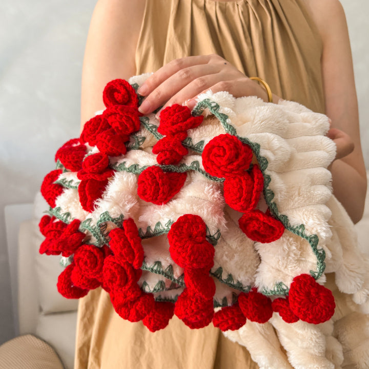 Cuddly blanket with crocheted rose trim and plush texture