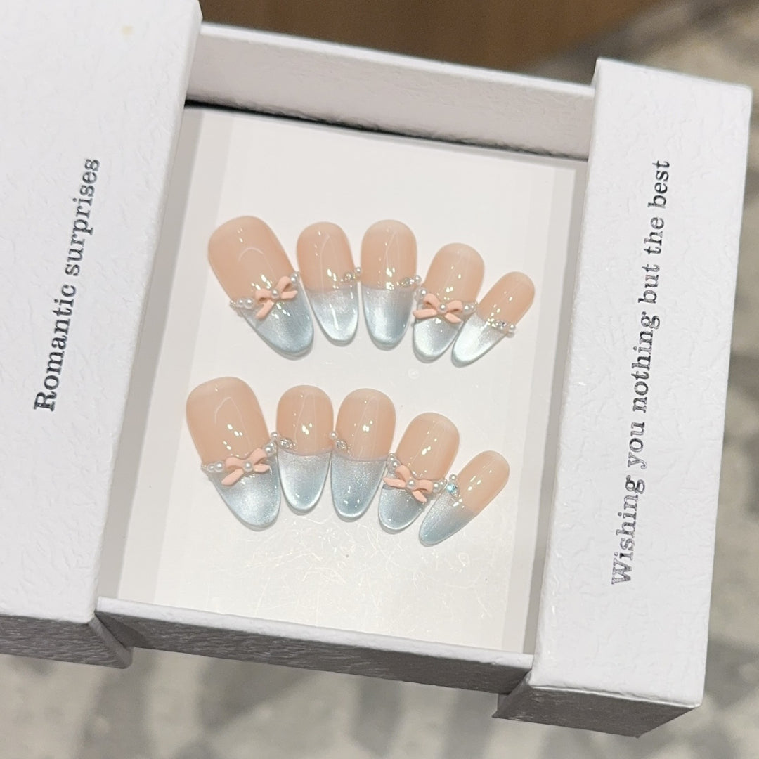 Artificial nail set with romantic bow and glitter accents Stornfield