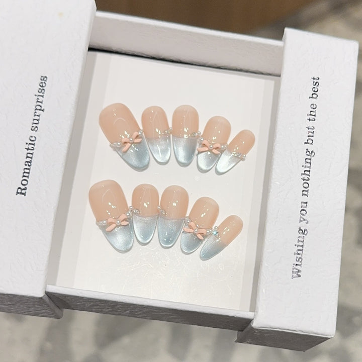 Artificial nail set with romantic bow and glitter accents Stornfield