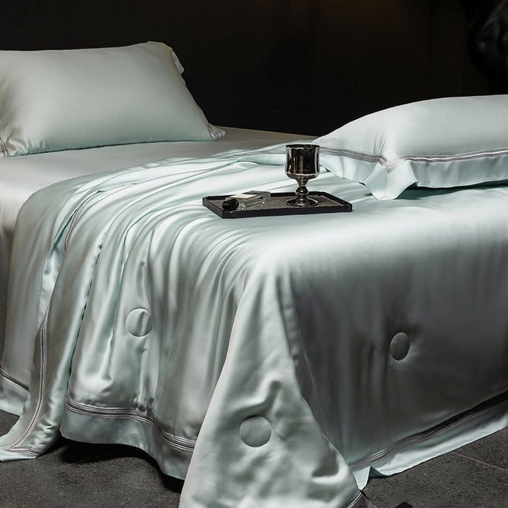 Luxurious satin bed set with silk-like surface and fine decorative stitching