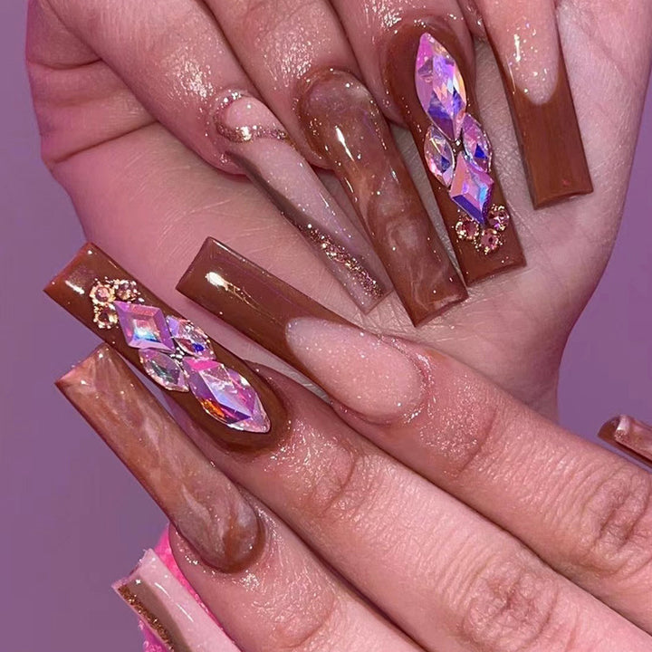 Artificial nail extensions with elegant gemstone embellishments Stornfield