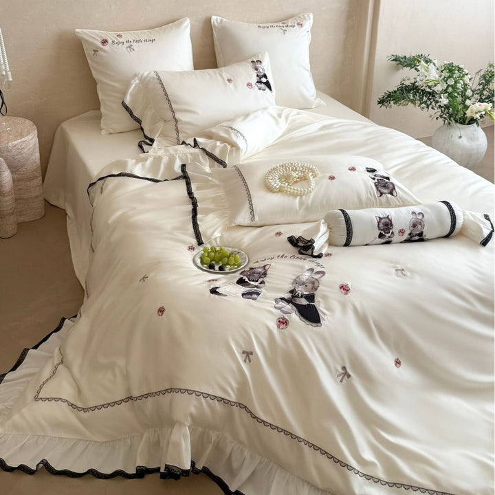 Embroidered satin bedding set with frill, ruffled hem, and animal motif