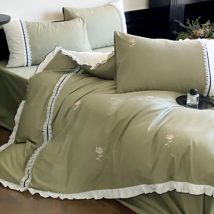 Cotton satin bed linen set with delicate rose embroidery, ruffled edge and contrasting reversible look