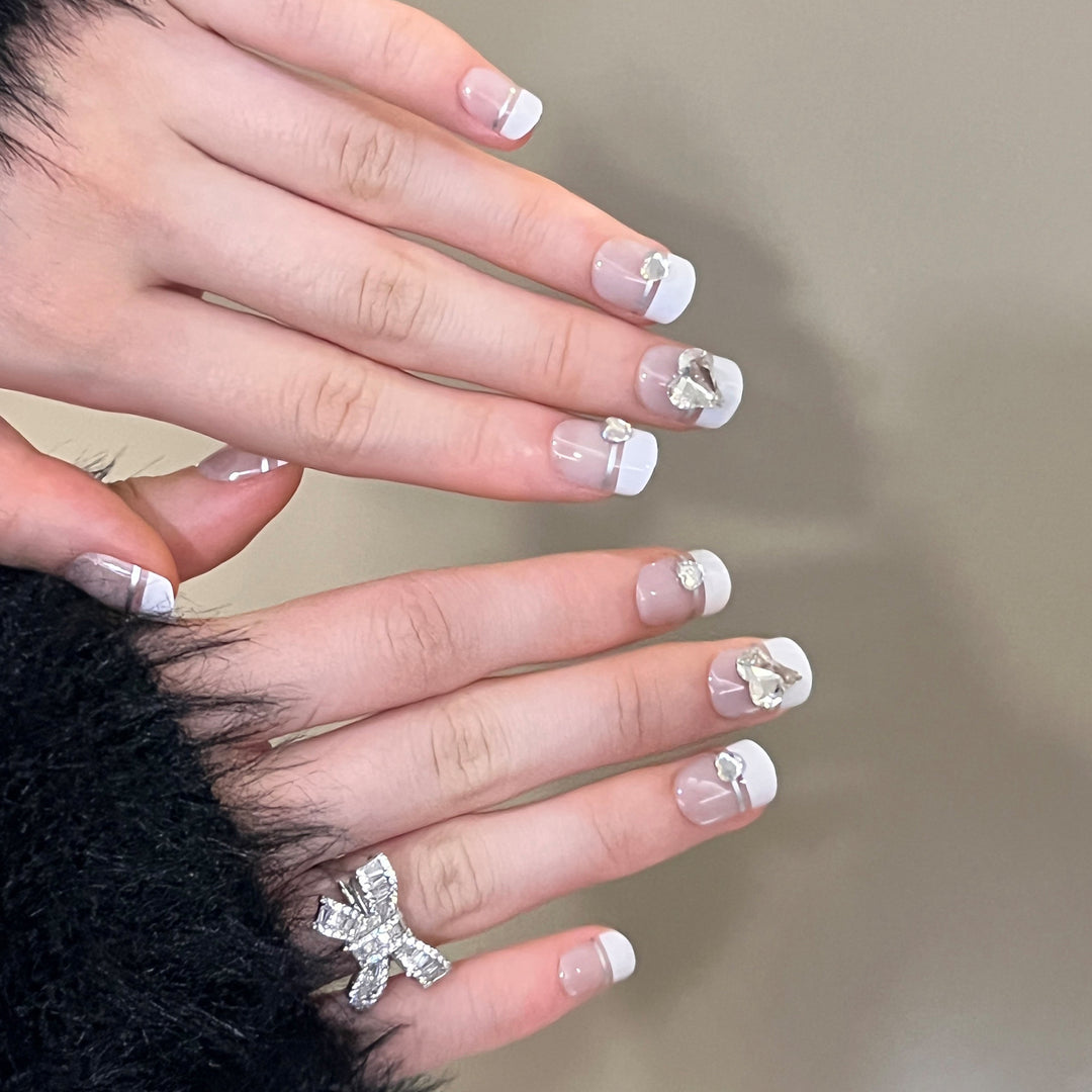 Elegant Nail Art with Glitter Accents and Jewelry Details Stornfield