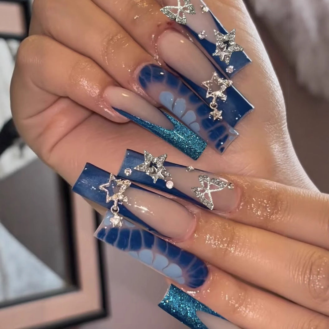Glamorous artificial nail tips with adorned stars and glitter Stornfield