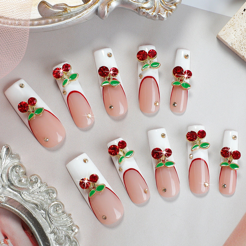 Artificial nail set with cherry motif and sparkling rhinestones Stornfield