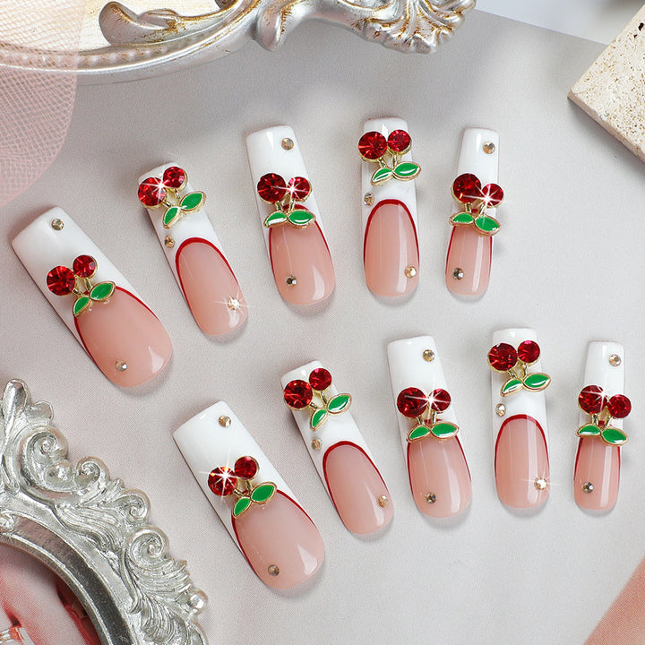 Artificial nail set with cherry motif and sparkling rhinestones Stornfield