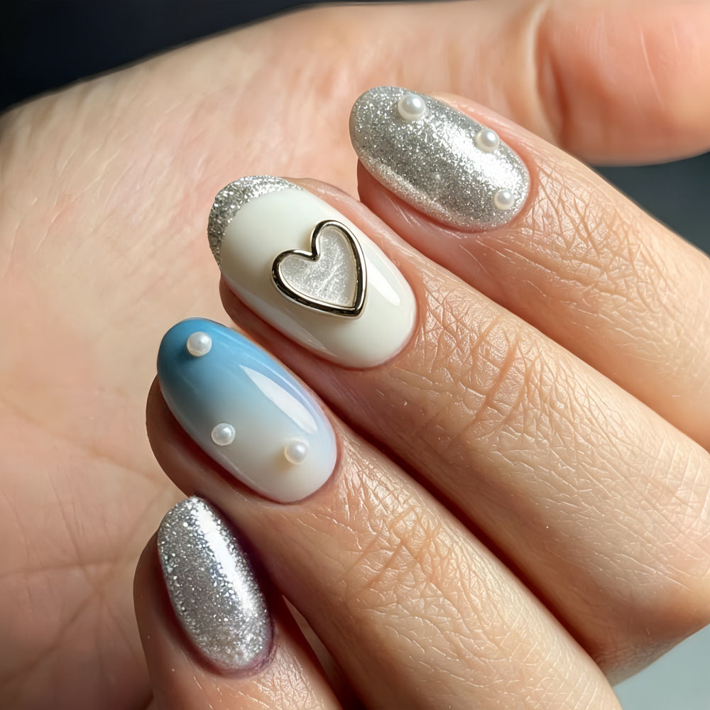 Glamorous artificial nails with heart design and pearl details Stornfield