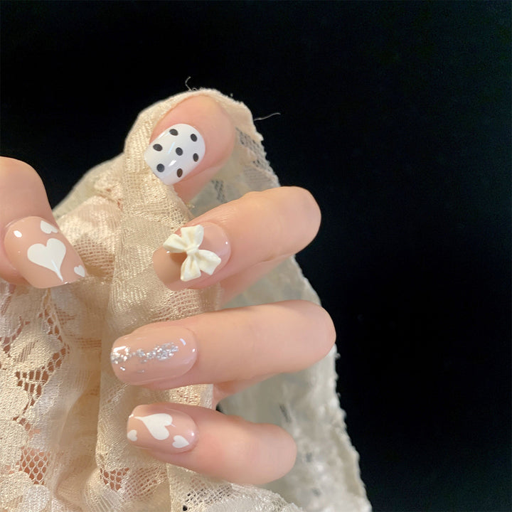 Artful nail art with delicate flower and heart motifs Stornfield