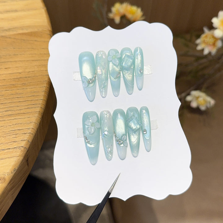 Artificial nails with floral designs and glitter effects Stornfield