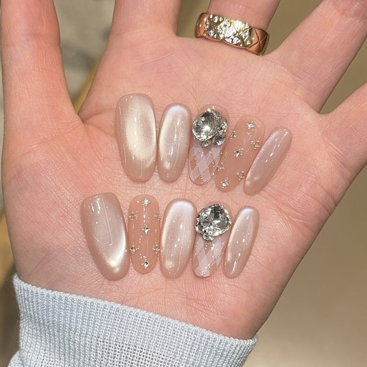 Elegant artificial nails with shimmering effects and rhinestone accents Stornfield