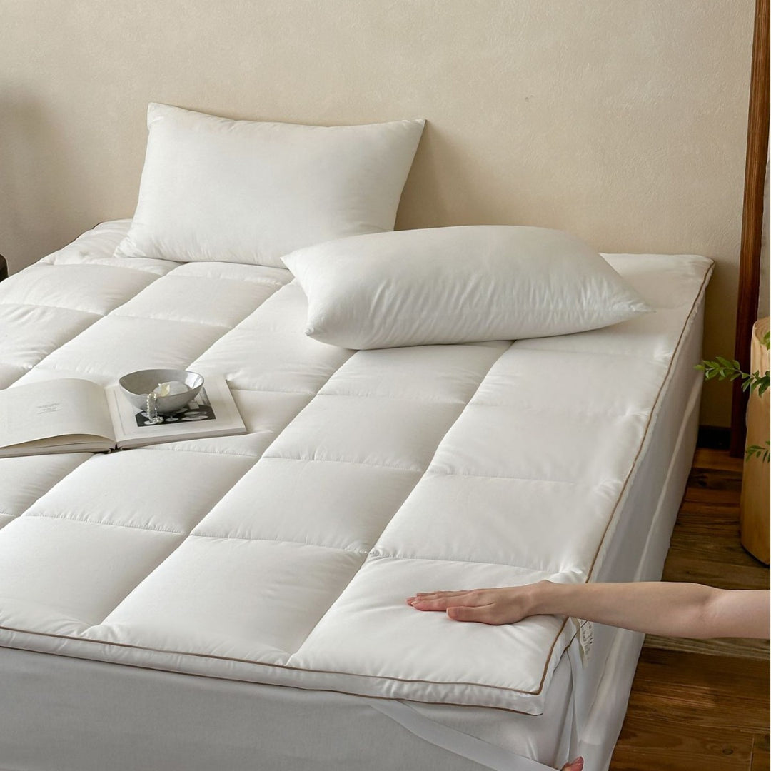 Padded comfort topper with quilted compartments and elastic corner bands