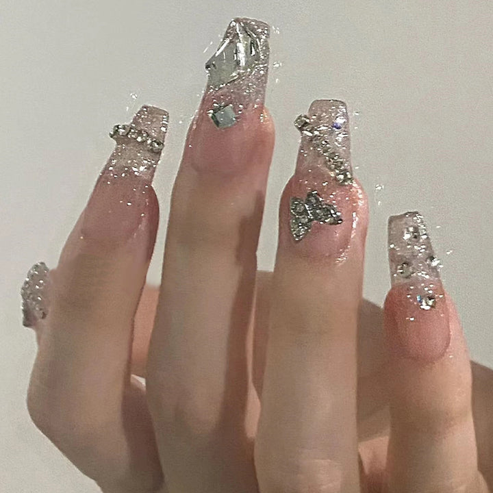 Glamorous artificial nails with delicate flower and glitter effects Stornfield