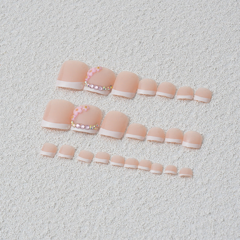 Elegant toenail art with delicate 3D floral decorations Stornfield