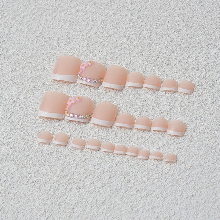 Elegant toenail art with delicate 3D floral decorations Stornfield