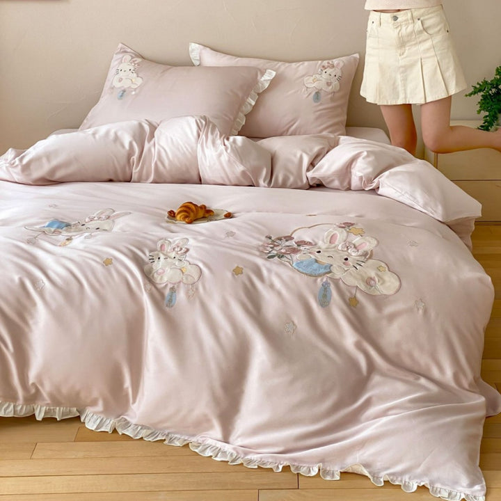 Playful children's bedding set made of silky-soft cotton satin with appliquéd bunnies and cuddly pillow