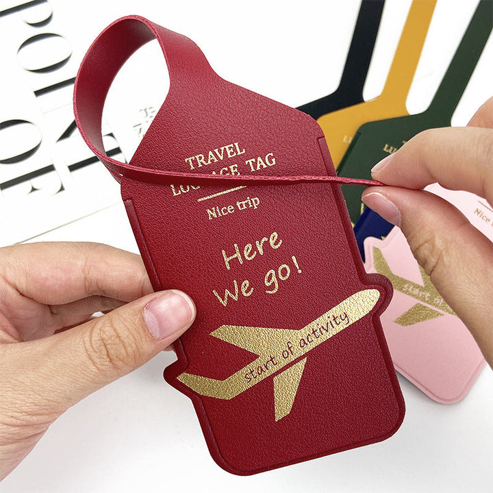 premium leather travel luggage ID tag with embossed airplane motif and adjustable strap Stornfield