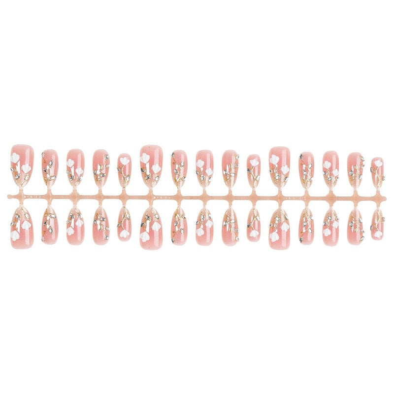 Artificial nail set with delicate floral patterns and elegant accents Stornfield