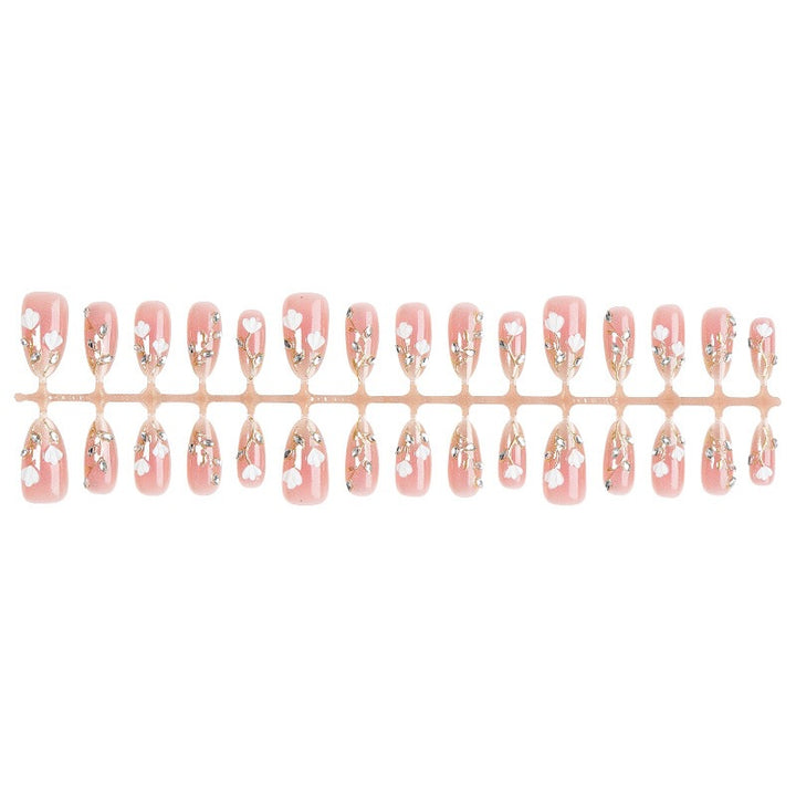 Artificial nail set with delicate floral patterns and elegant accents Stornfield