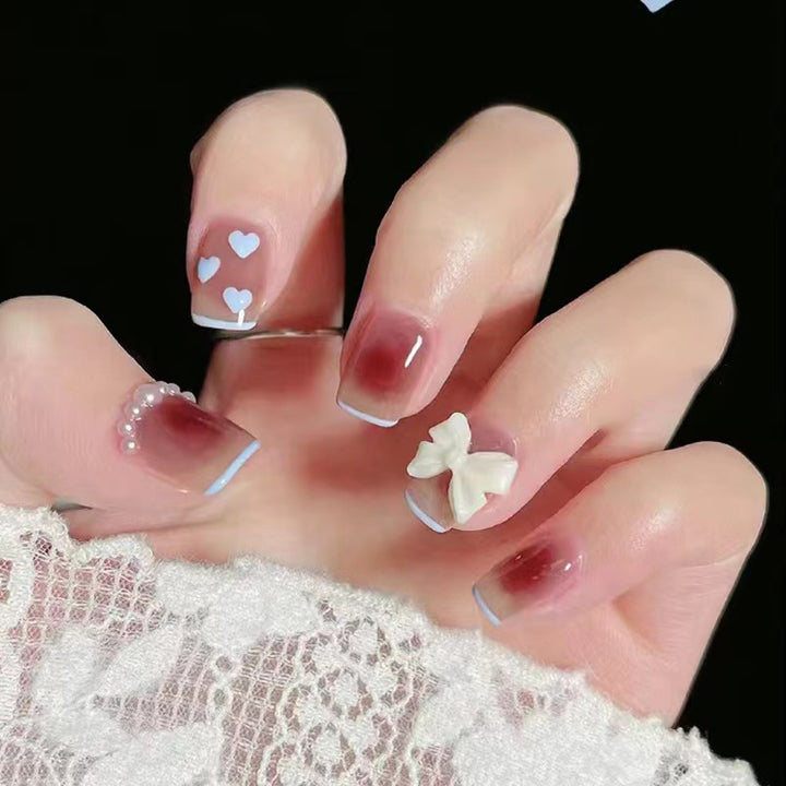 Artistic and elegant nail art with bow accents Stornfield