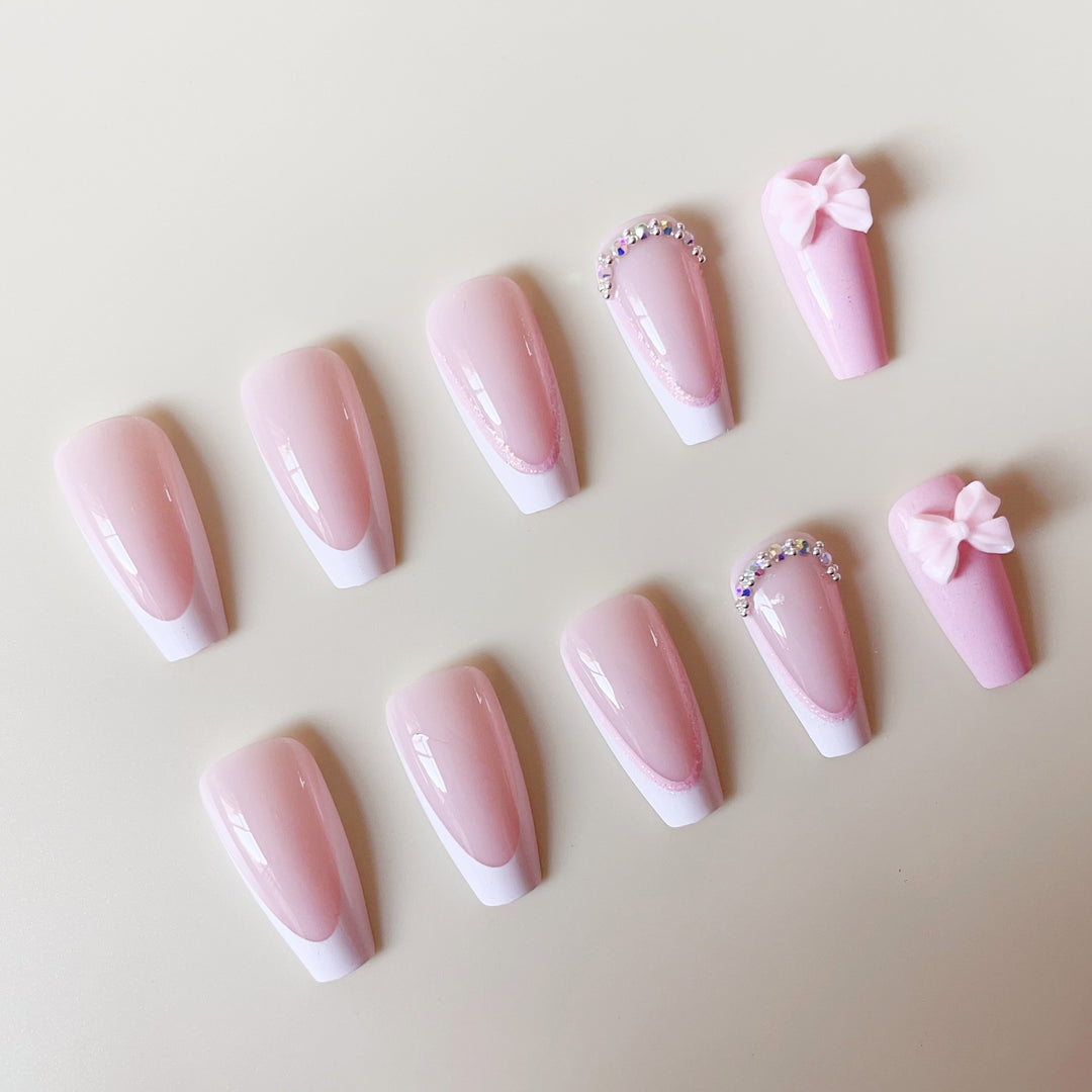 Artificial nail set with playful bows and glitter accents Stornfield