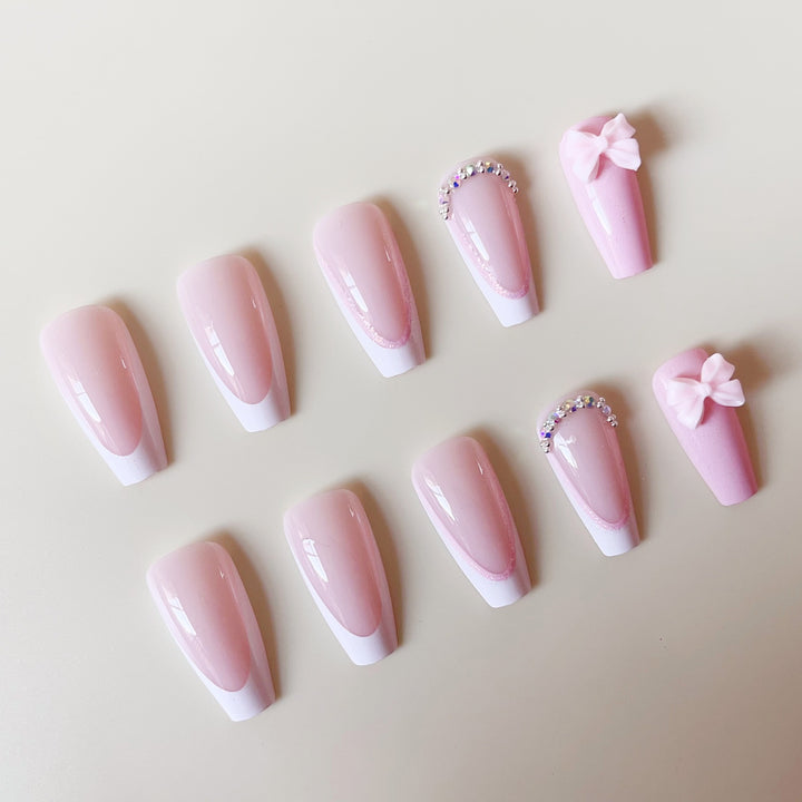 Artificial nail set with playful bows and glitter accents Stornfield