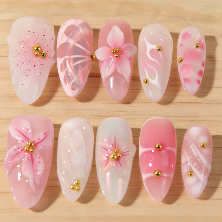 Artificial nails with floral designs and glitter accents Stornfield