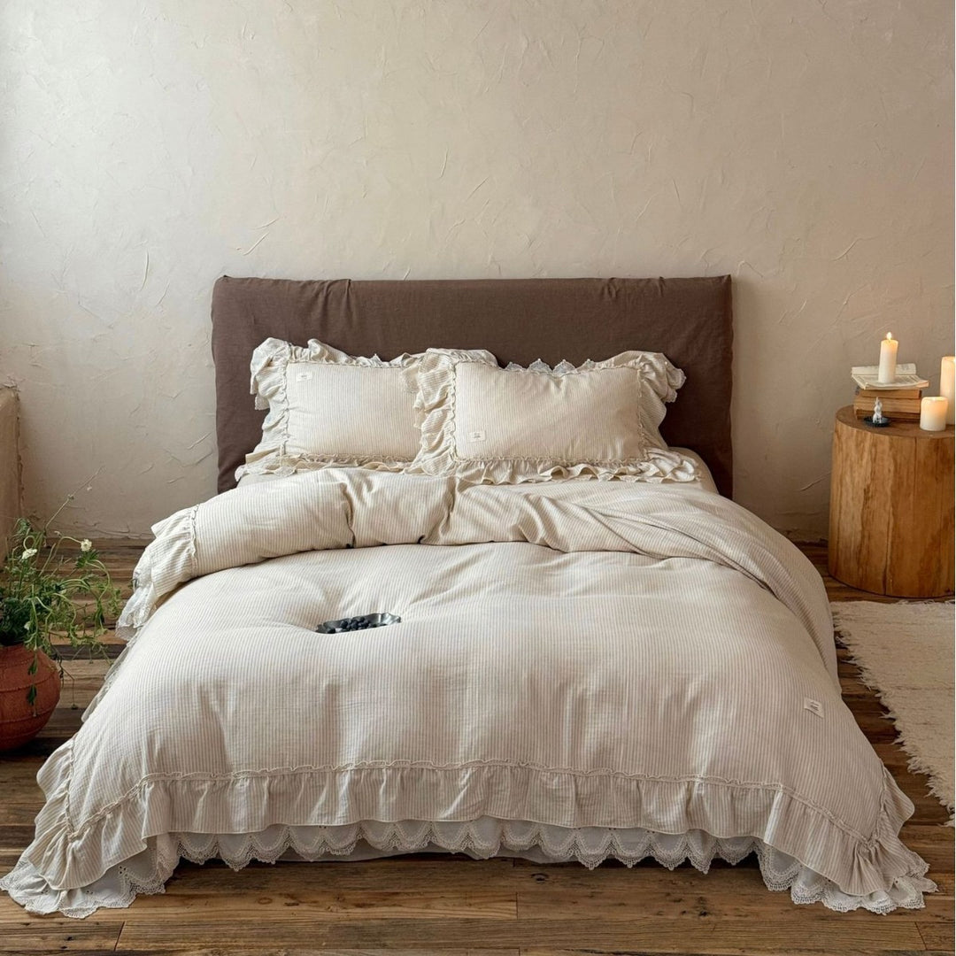 Country house style bed linen set with ruffles, lace border and quilted bedspread