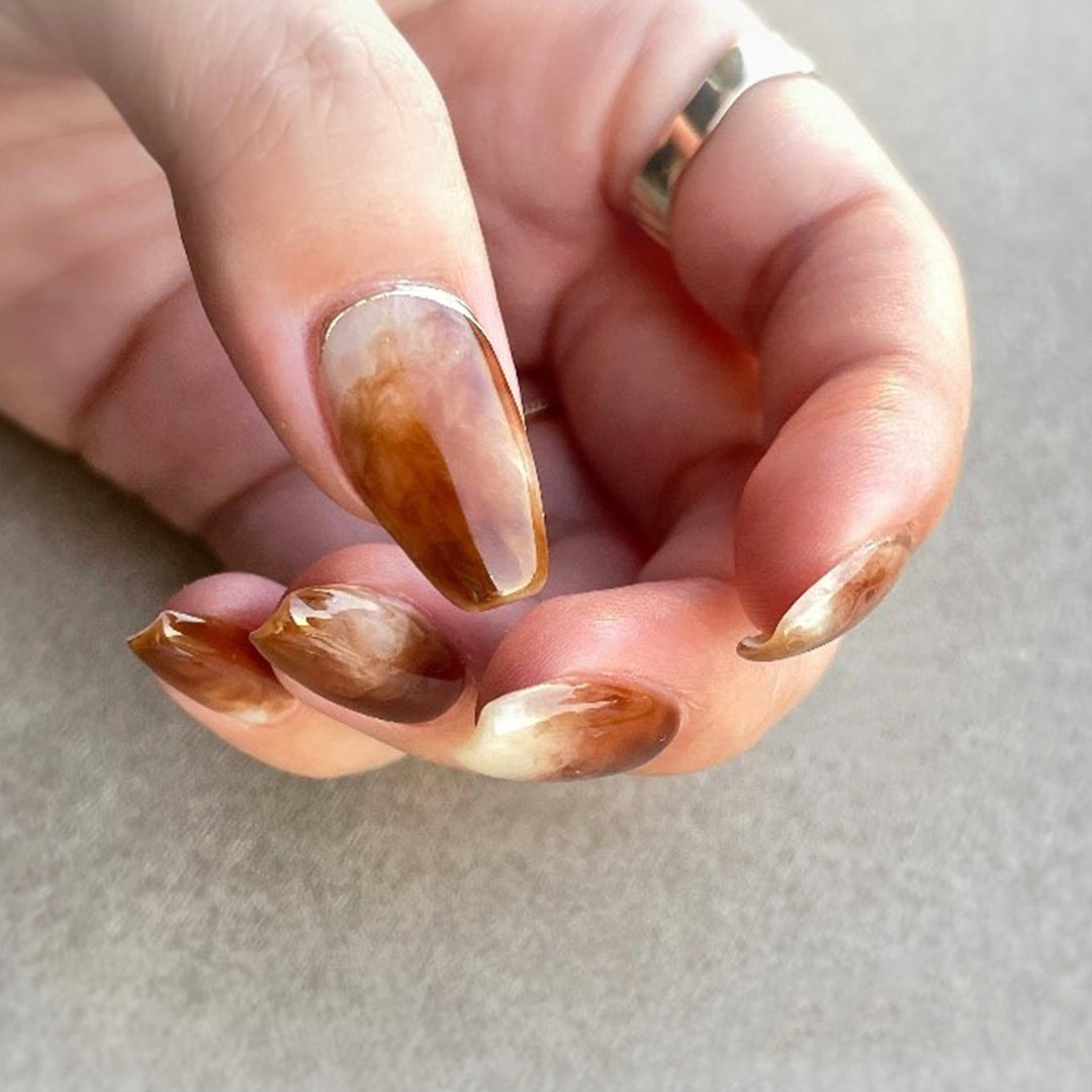 Artful nail extensions with an elegant leaf pattern Stornfield