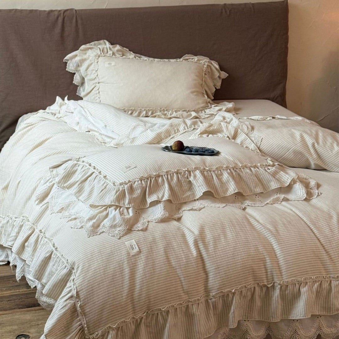Country house style bed linen set with ruffles, lace border and quilted bedspread