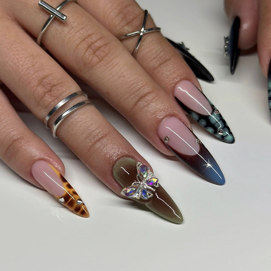 Artful nail extensions with elegant designs and glitter Stornfield