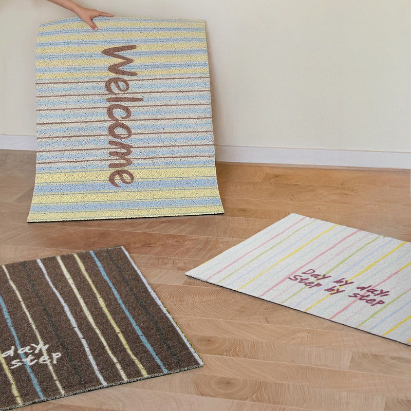 Durable entrance doormat with striped texture and "Welcome" lettering Stornfield