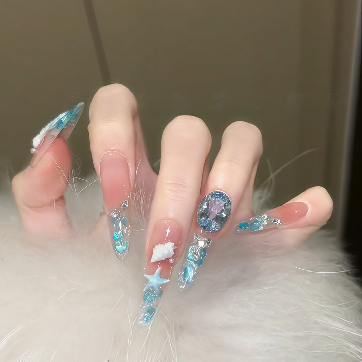 Creative artificial nails with maritime designs and sparkling accents Stornfield