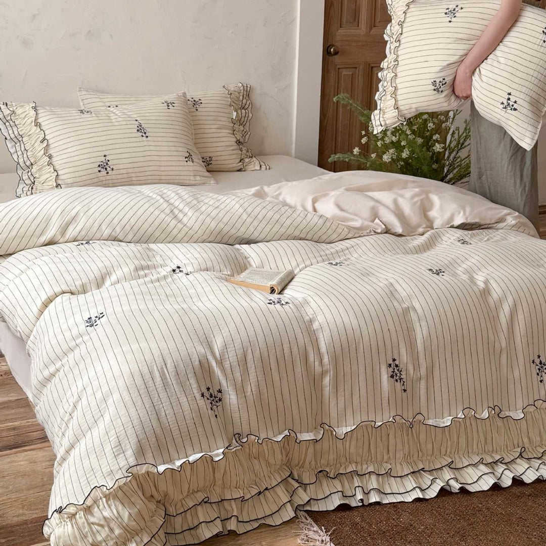 Romantic bedding set with ruffle, fine floral embroidery and pinstripes