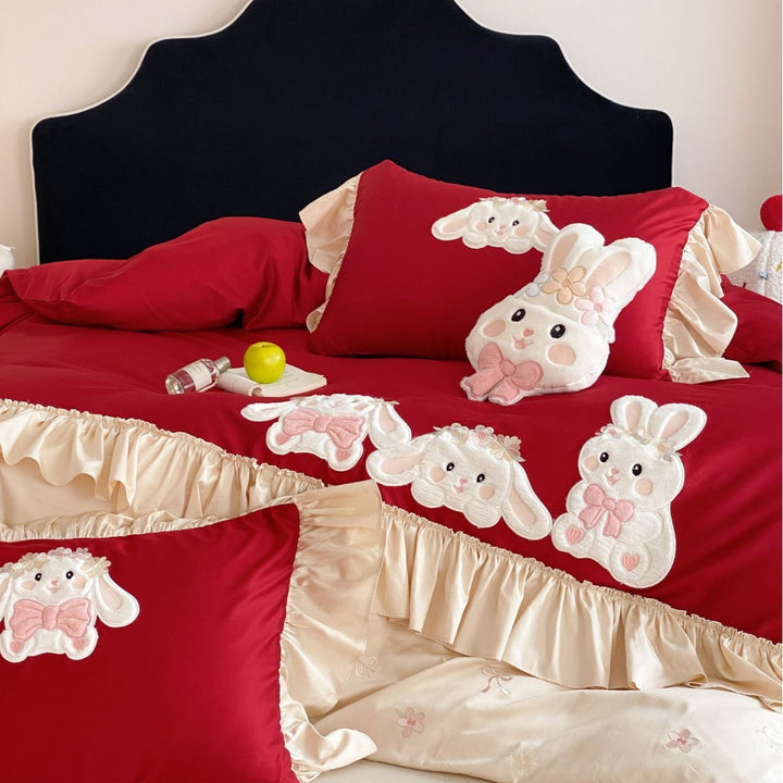 Playful bedding set with ruffles, three-dimensional appliqués, and delicate embroidery