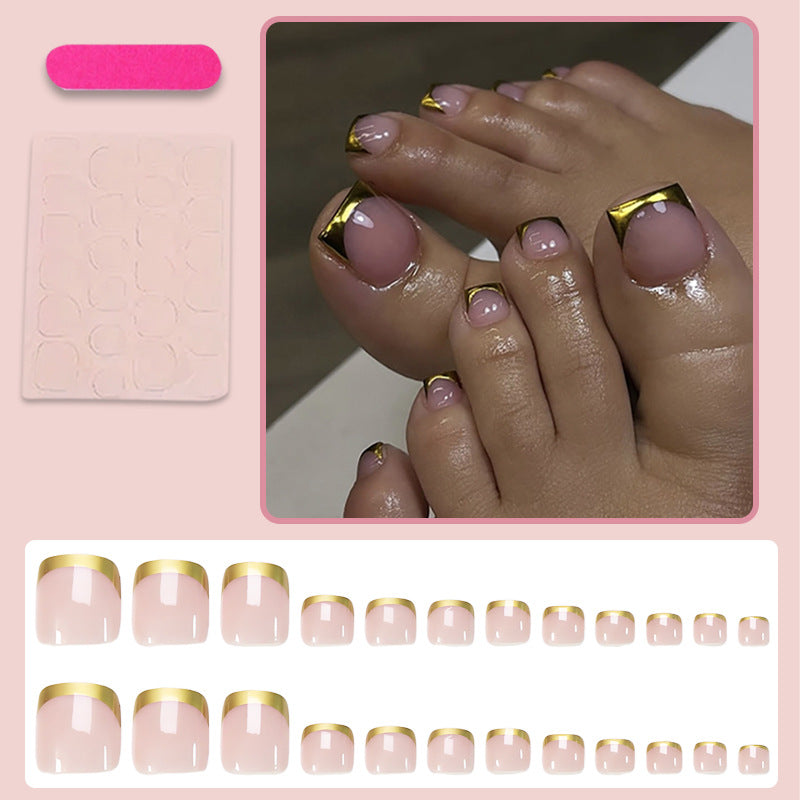 Toenail art set with elegant gold tips and delicate embellishments Stornfield