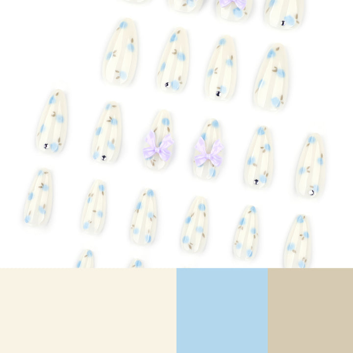 Artful stiletto nails with delicate flower patterns and glitter accents Stornfield