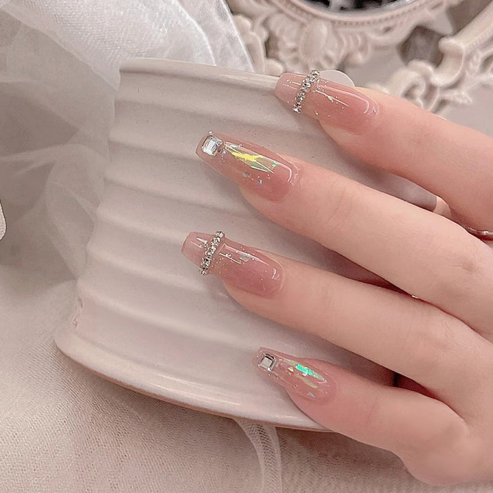 Acrylic nail set with glamorous rhinestone and glitter elements Stornfield