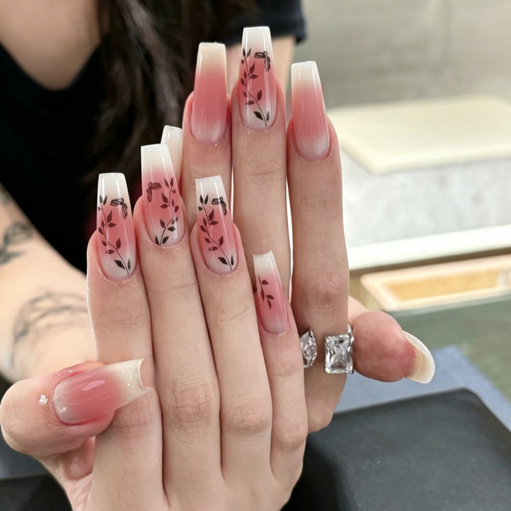 Artificial nails with elegant ombre design and floral accents Stornfield