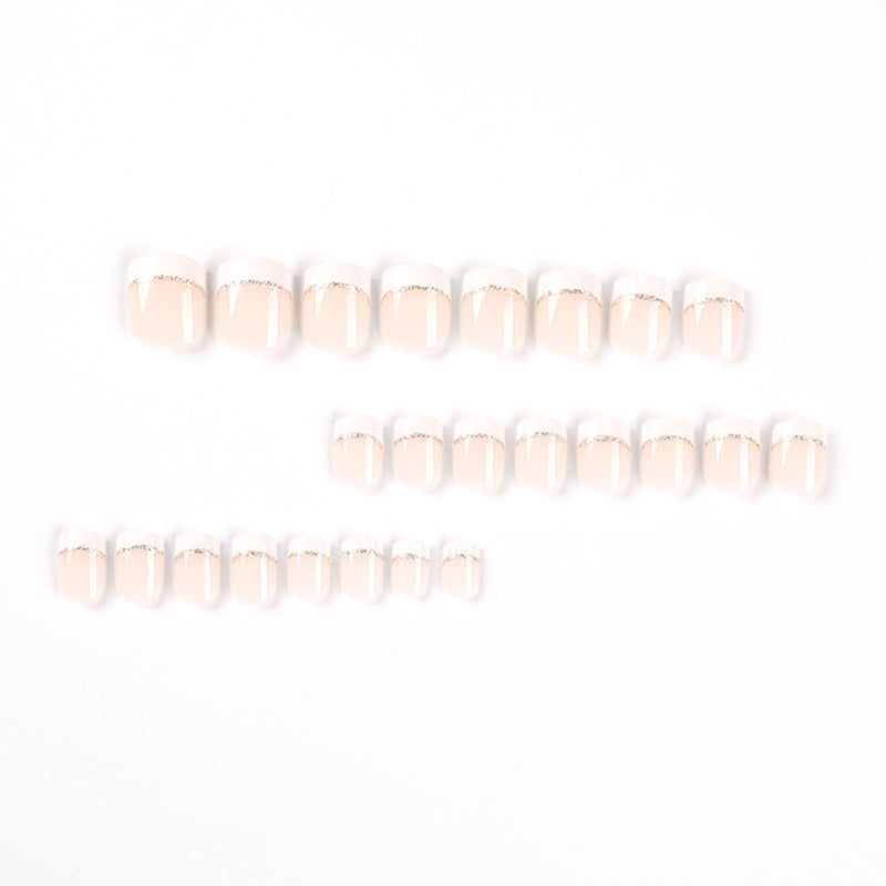 Artful nail extensions with elegant French tip and gold accents Stornfield