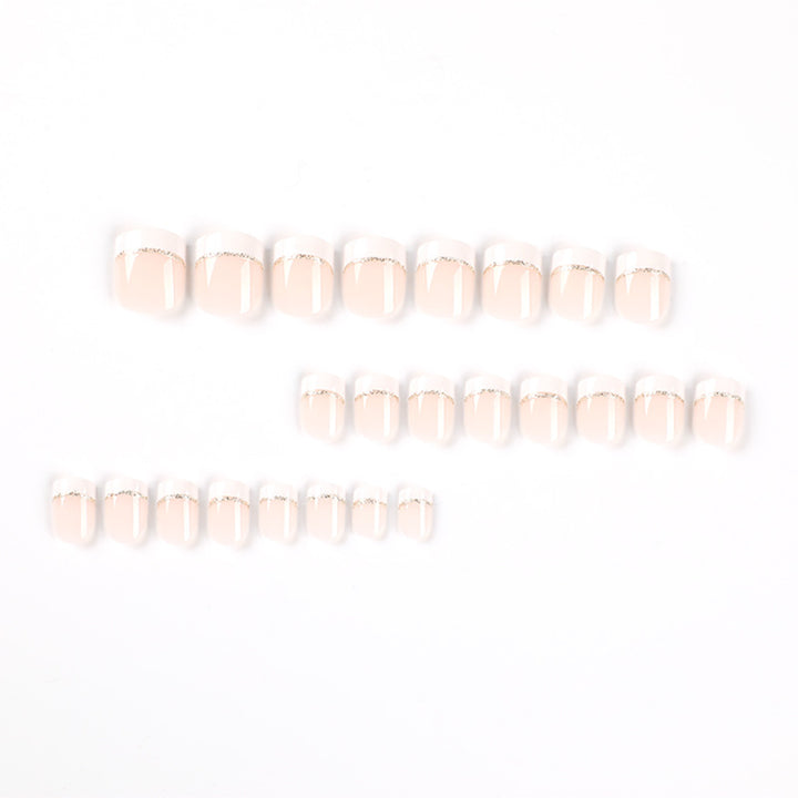 Artful nail extensions with elegant French tip and gold accents Stornfield