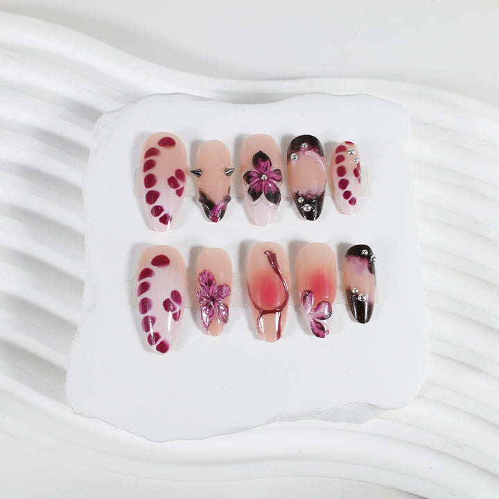 Acrylic nail set with elegant floral design and glossy accents Stornfield