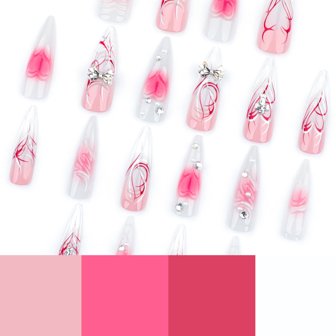 Artful stiletto nails with elegant floral accents and glitter embellishments Stornfield