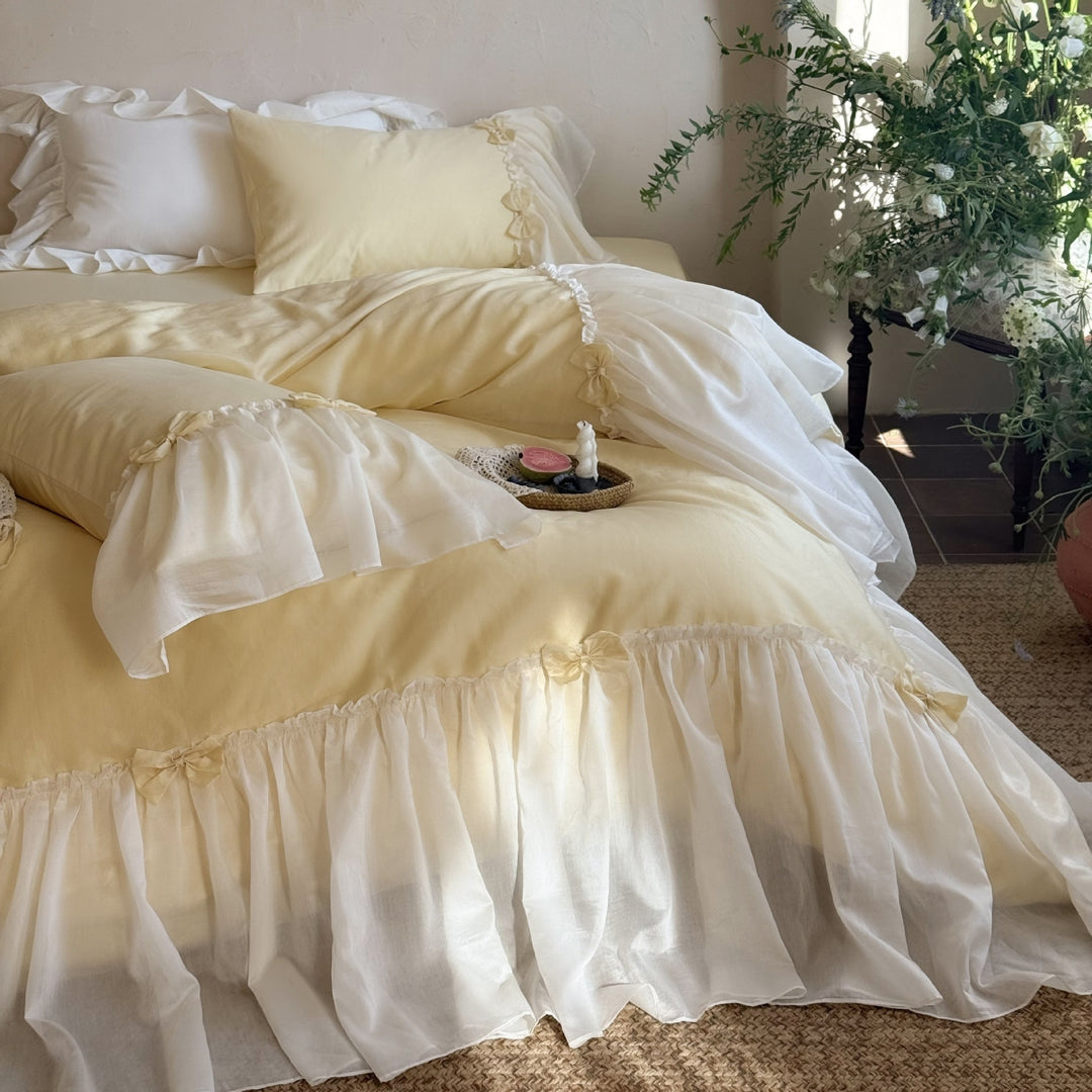 Bedding set with ruffled bed skirt, ruffle cushion and bow application